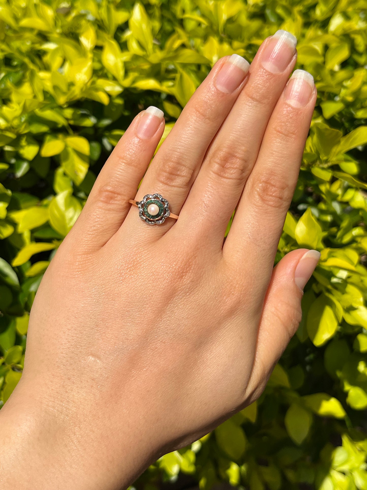 9K gold Edwardian pearl, emerald, and diamond flower ring.