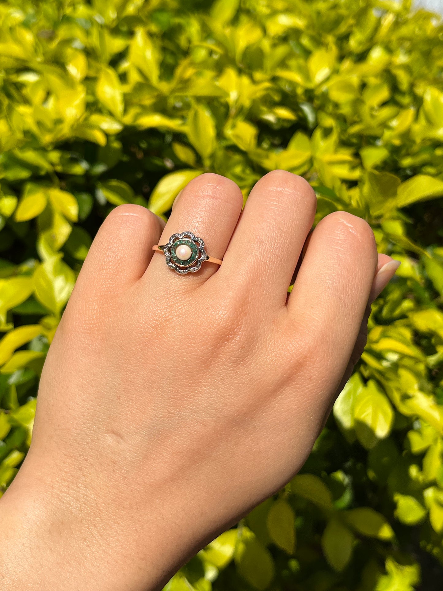 9K gold Edwardian pearl, emerald, and diamond flower ring.