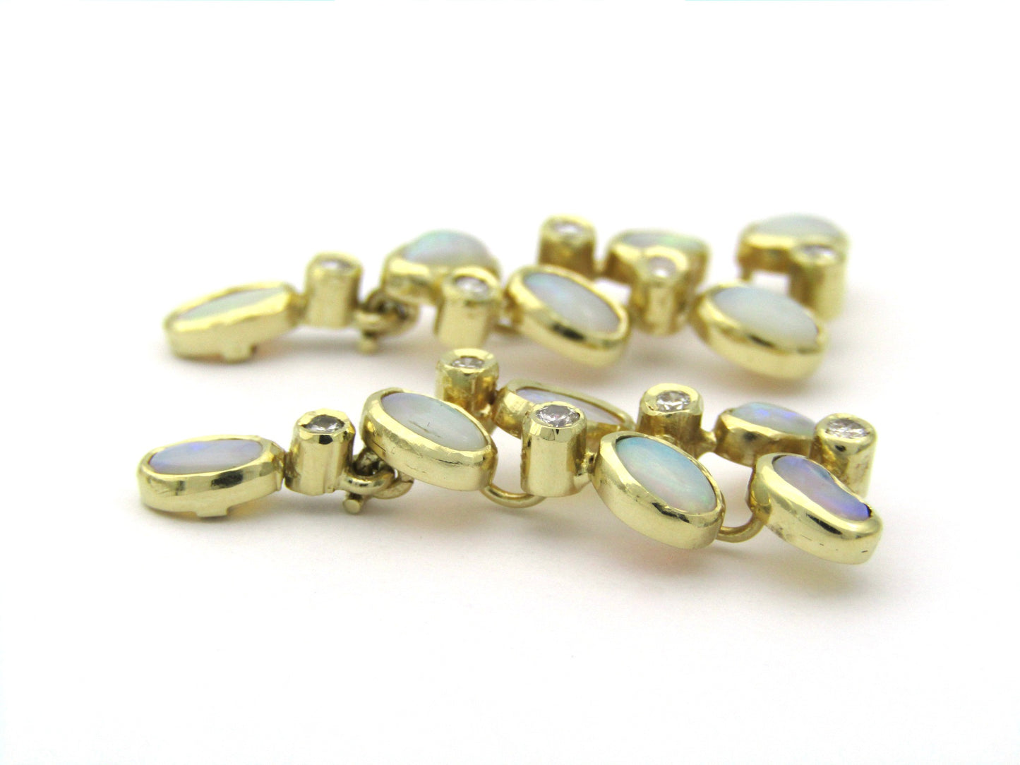 14K gold opal and diamond drop earrings.