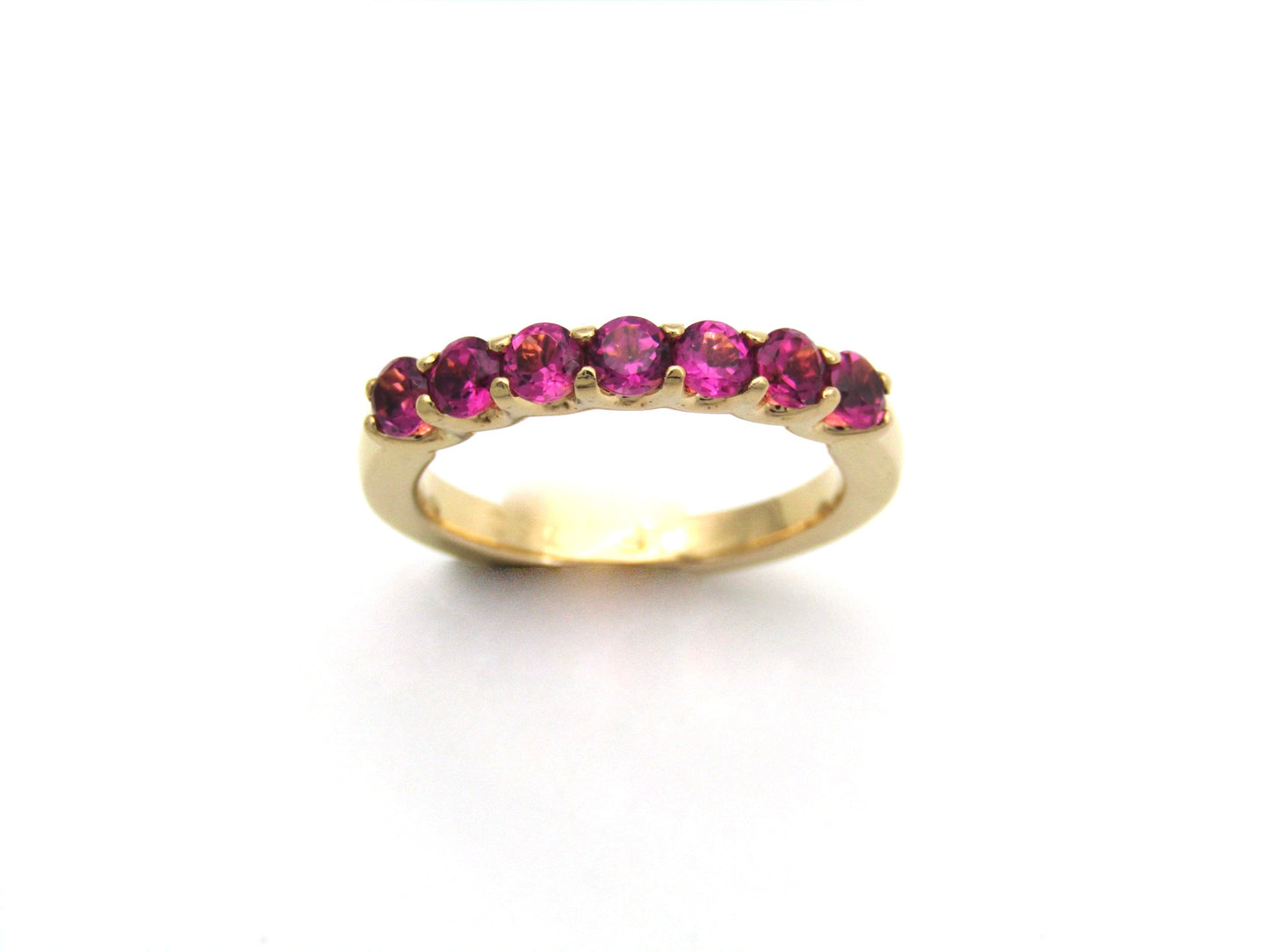 18K gold pink tourmaline half eternity ring.