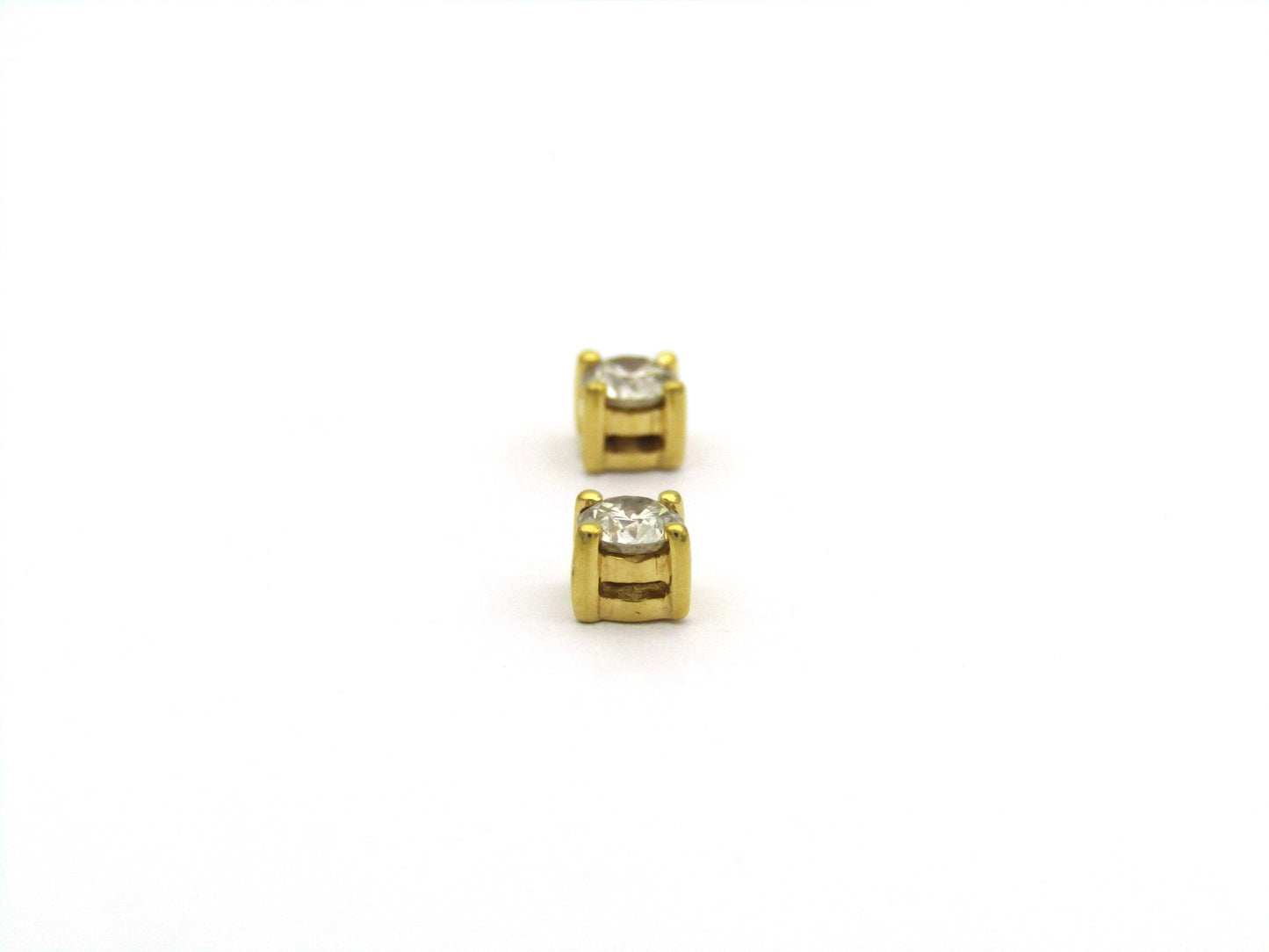 18K gold diamond stud earrings.