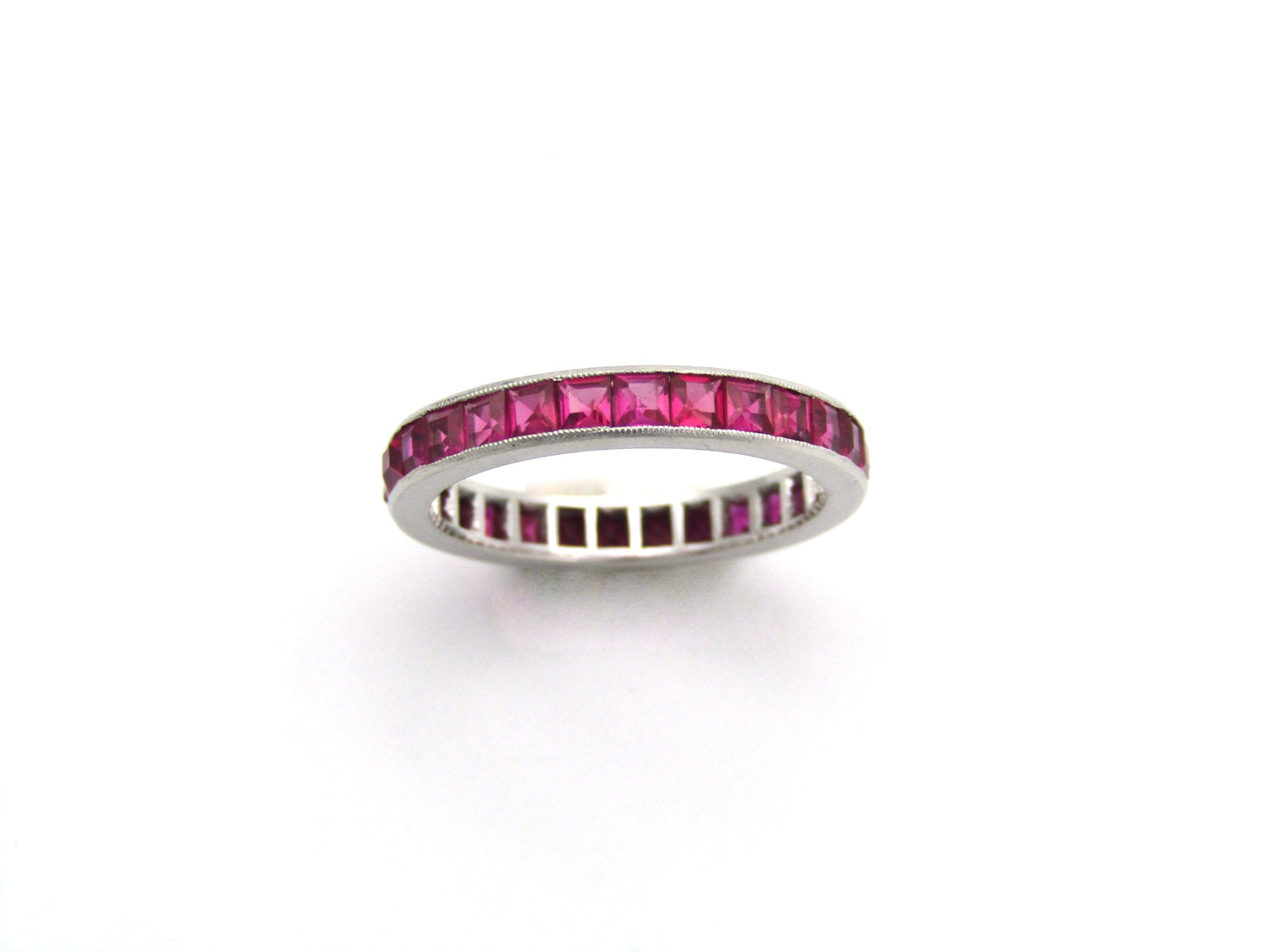 Platinum synthetic ruby eternity ring, circa 1990's.