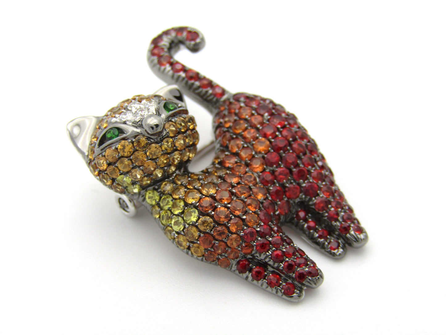 18K gold fancy sapphire, tsavorite garnet and diamond cat pendant/brooch.