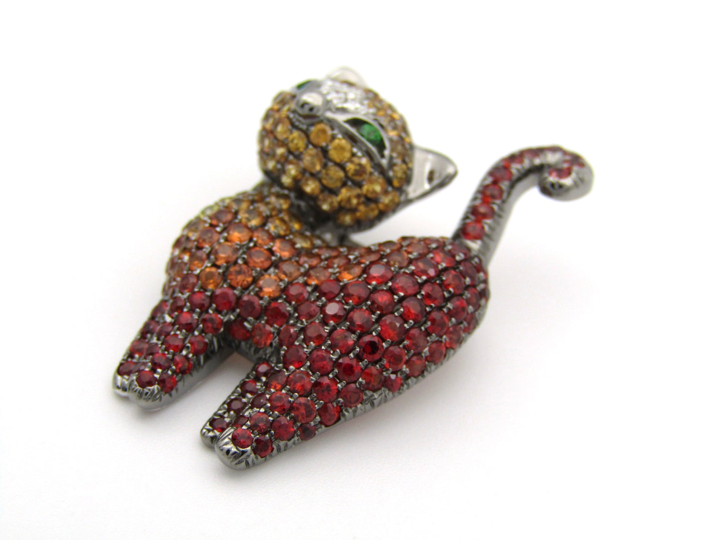 18K gold fancy sapphire, tsavorite garnet and diamond cat pendant/brooch.