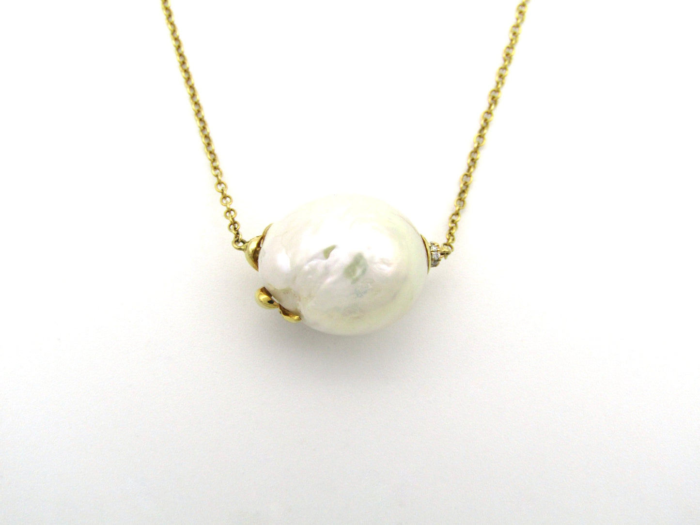 14K gold baroque pearl and diamond floating necklace.