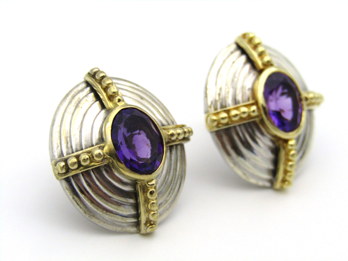 A pair of 18kt and 9kt gold amethyst earrings.