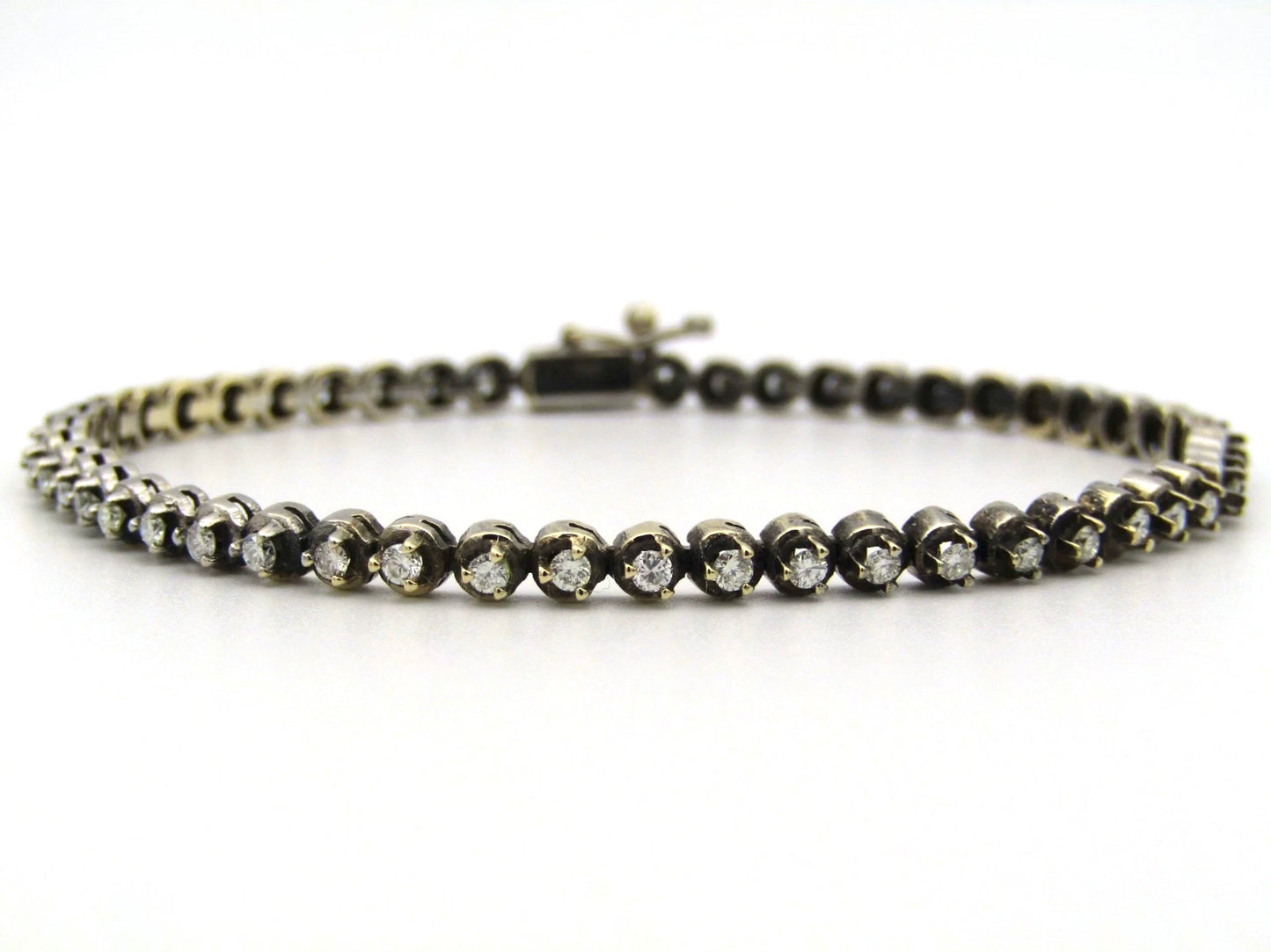 14K gold diamond tennis bracelet.