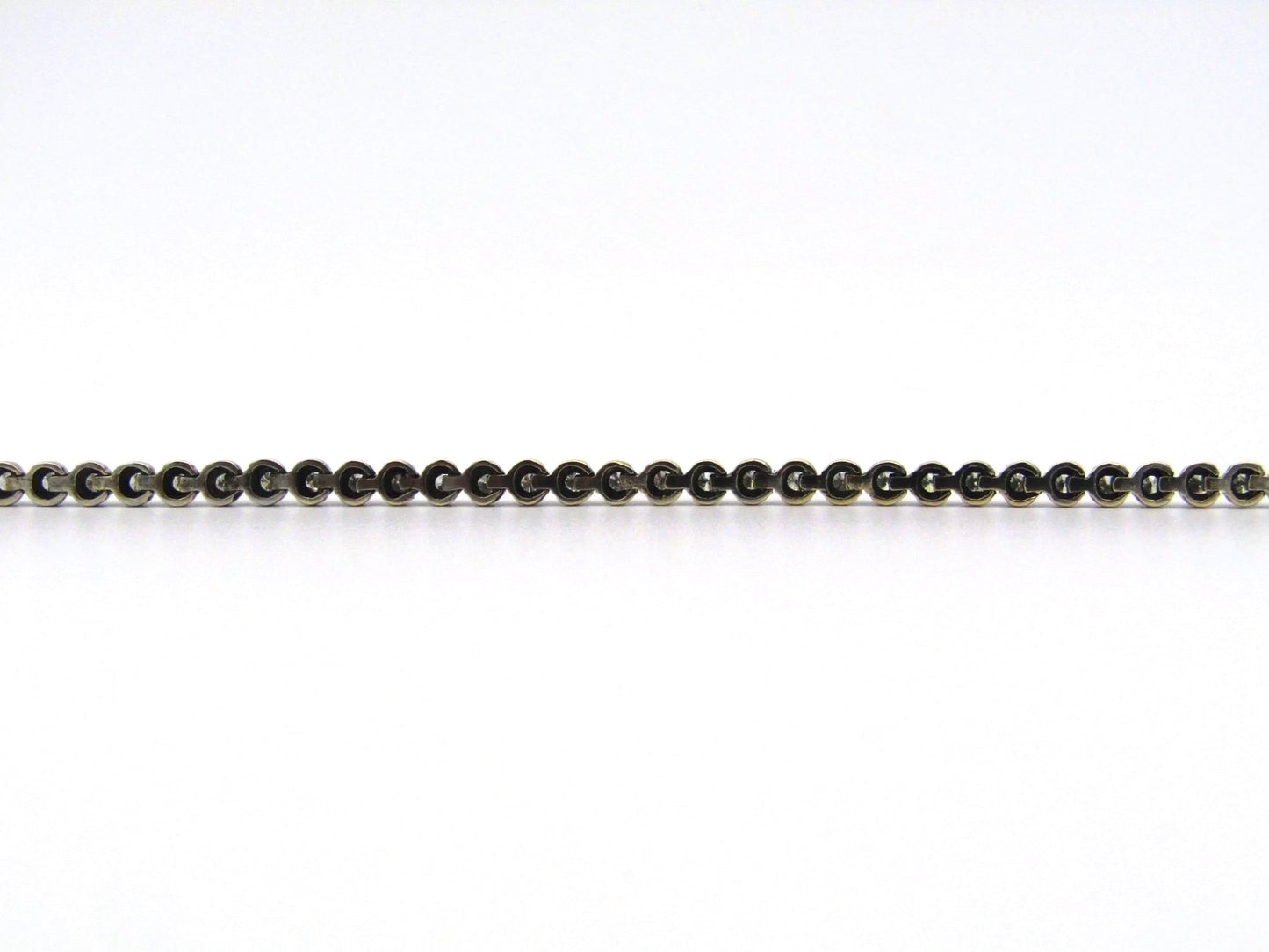 14K gold diamond tennis bracelet.