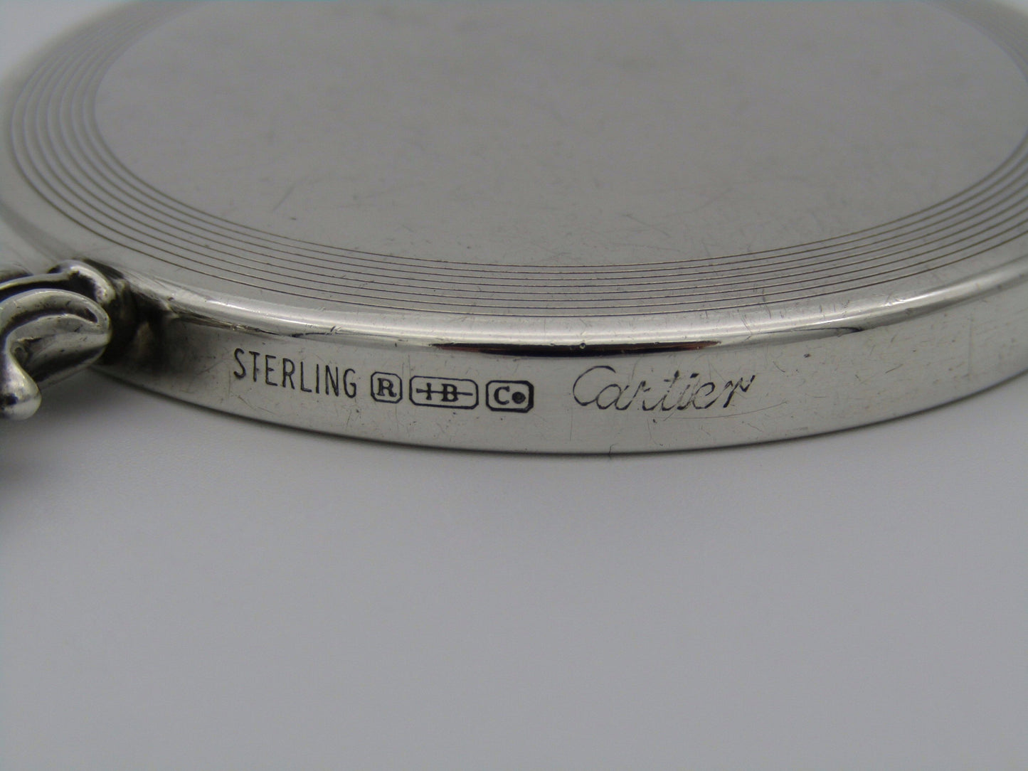 A sterling silver hand mirror by Cartier. Circa 1920s.