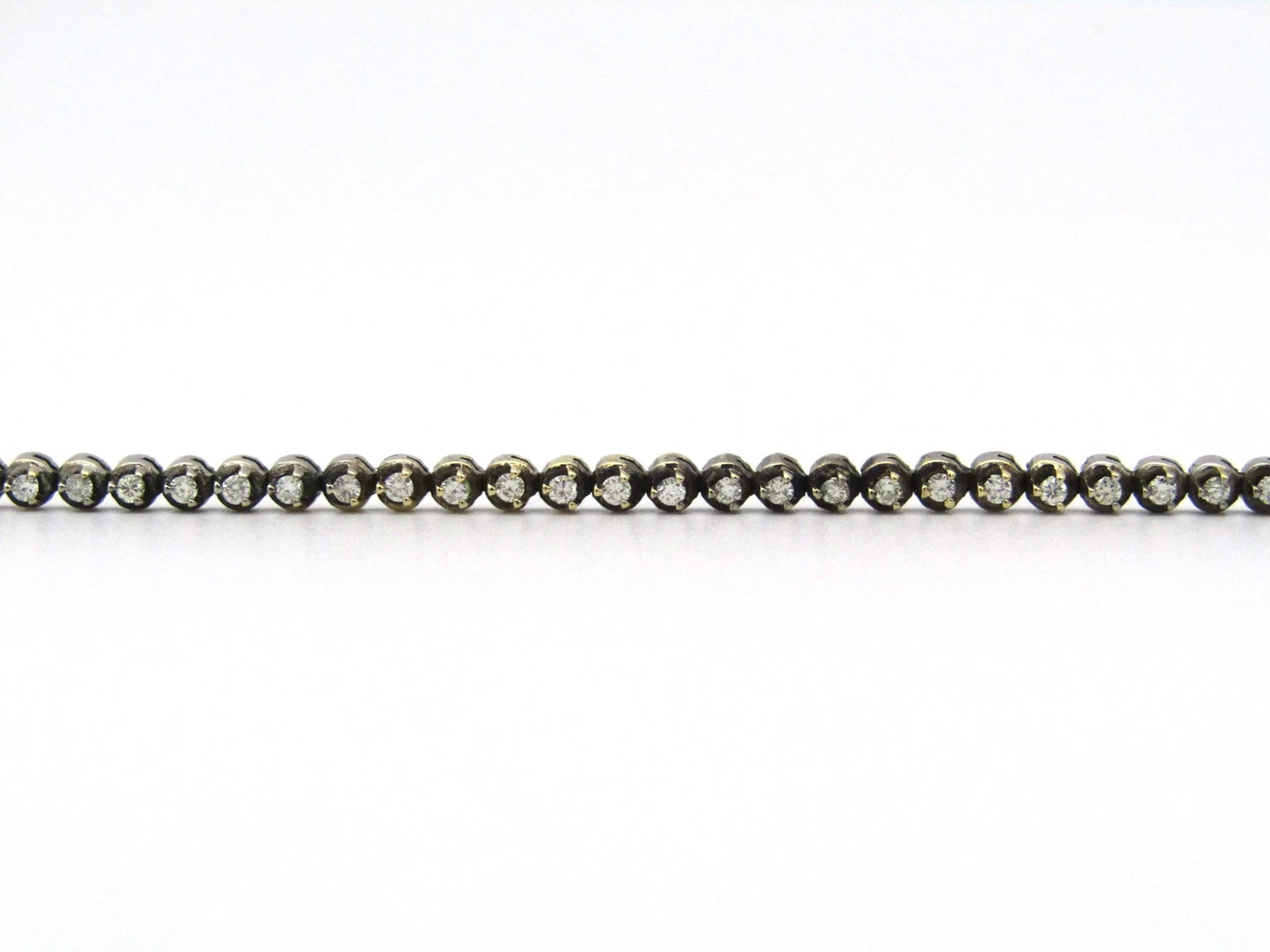 14K gold diamond tennis bracelet.