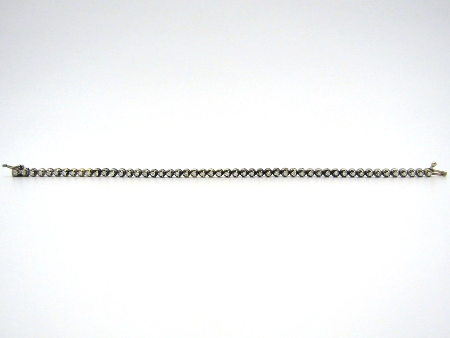 14K gold diamond tennis bracelet.
