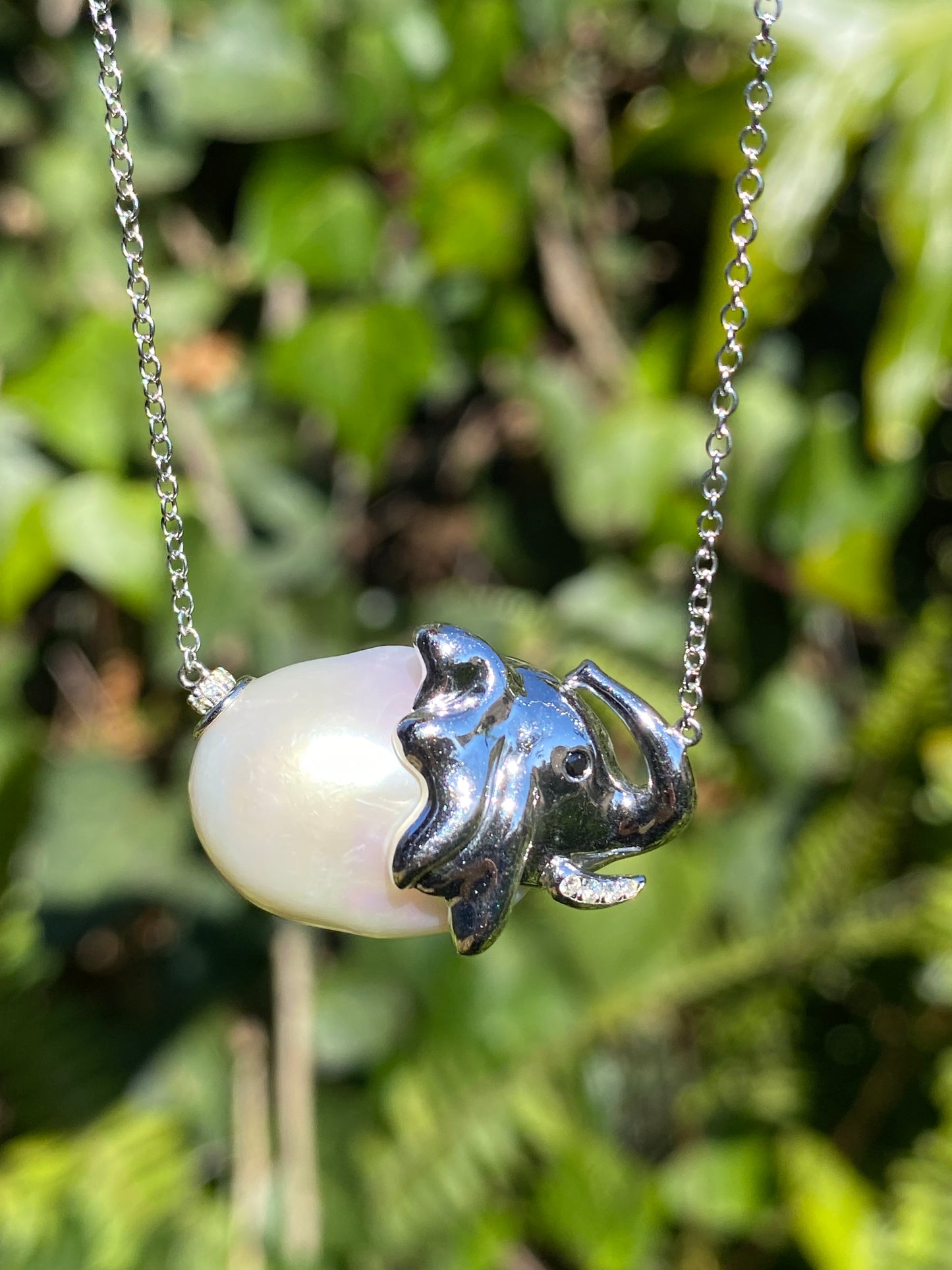 14K gold floating baroque pearl and diamond elephant necklace.