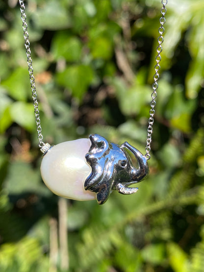 14K gold floating baroque pearl and diamond elephant necklace.
