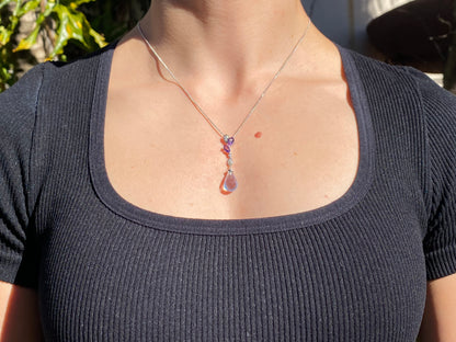 18K gold blue topaz, amethyst, and diamond pendant.