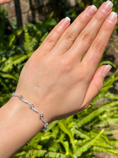 18K gold diamond wave link bracelet.