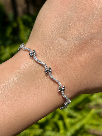 18K gold diamond wave link bracelet.