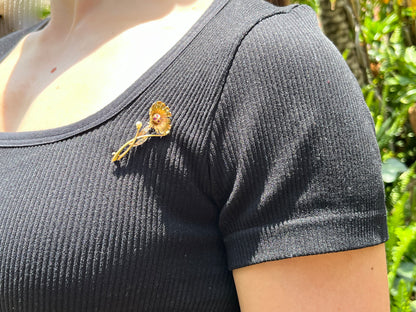22K gold Edwardian ruby, diamond, and pearl sunflower brooch, circa 1900.