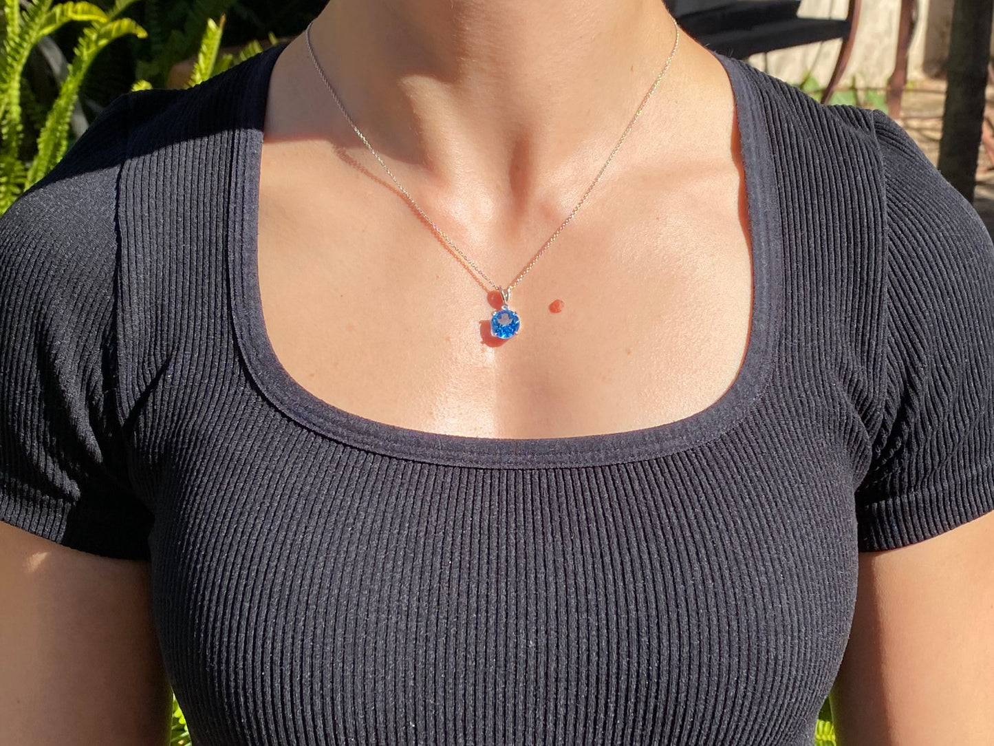 9K gold blue topaz and diamond pendant.