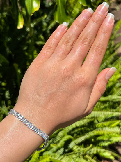 18K gold triple row diamond tennis bracelet.