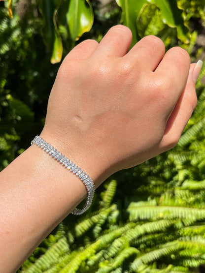 18K gold triple row diamond tennis bracelet.