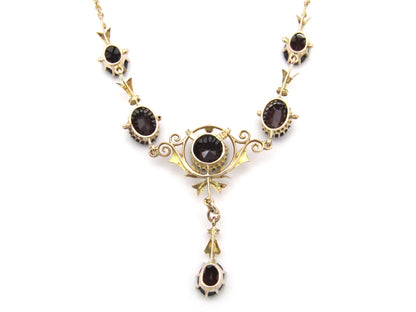 9K gold Edwardian garnet necklace, circa 1910.