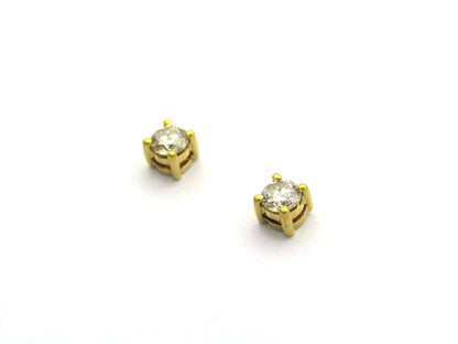 18K gold diamond stud earrings.
