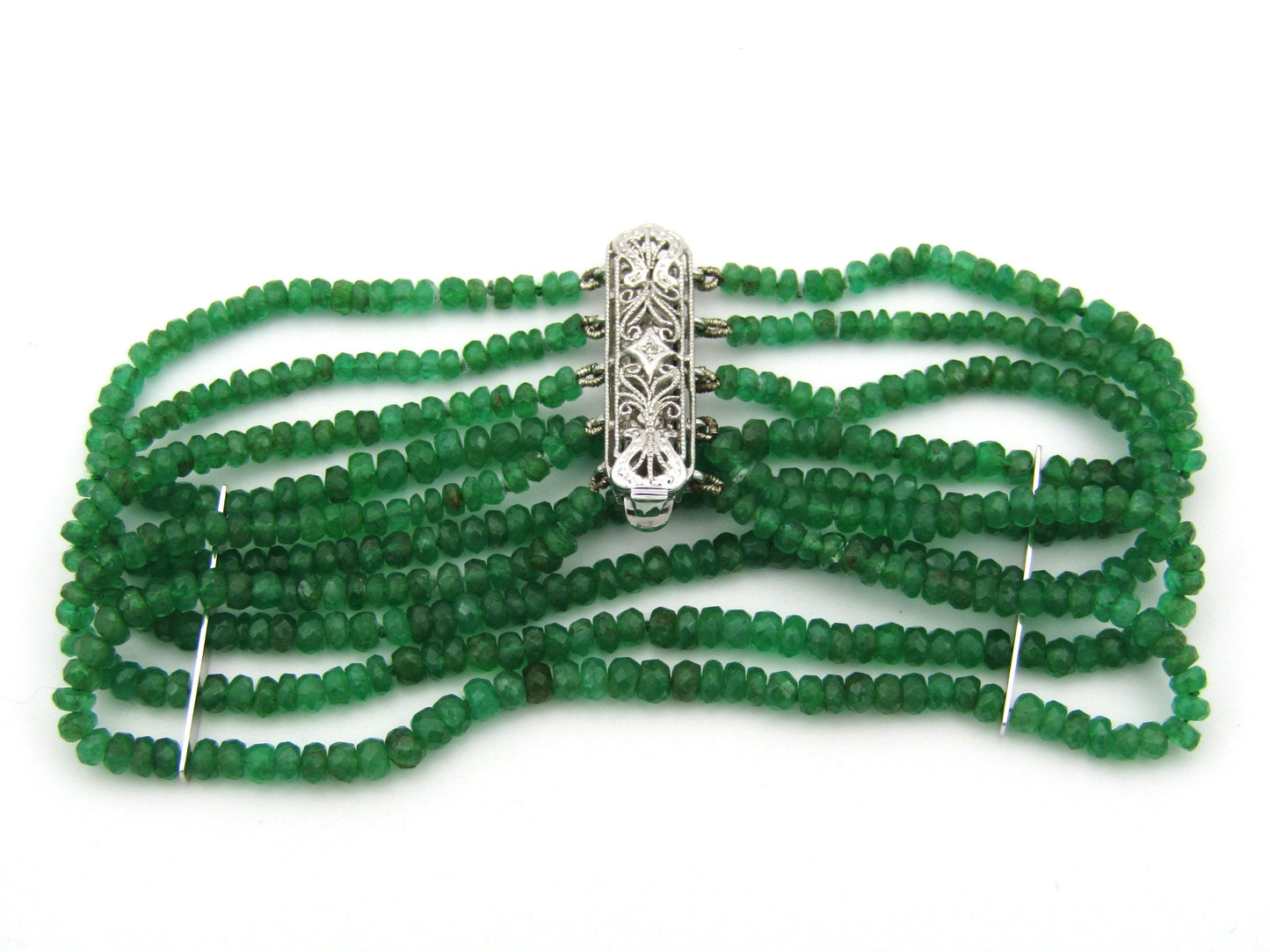 14K gold diamond and 5 strand emerald bracelet.