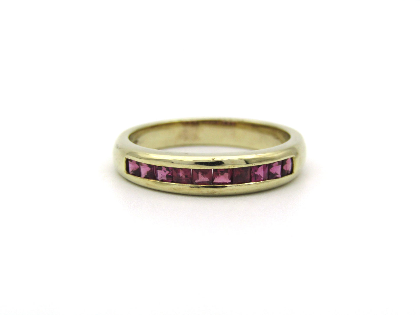 9K gold rhodolite garnet half eternity ring.