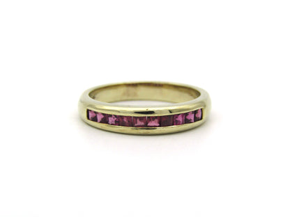 9K gold rhodolite garnet half eternity ring.