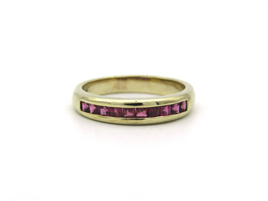 9K gold rhodolite garnet half eternity ring.