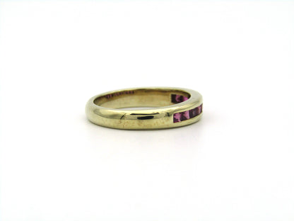 9K gold rhodolite garnet half eternity ring.