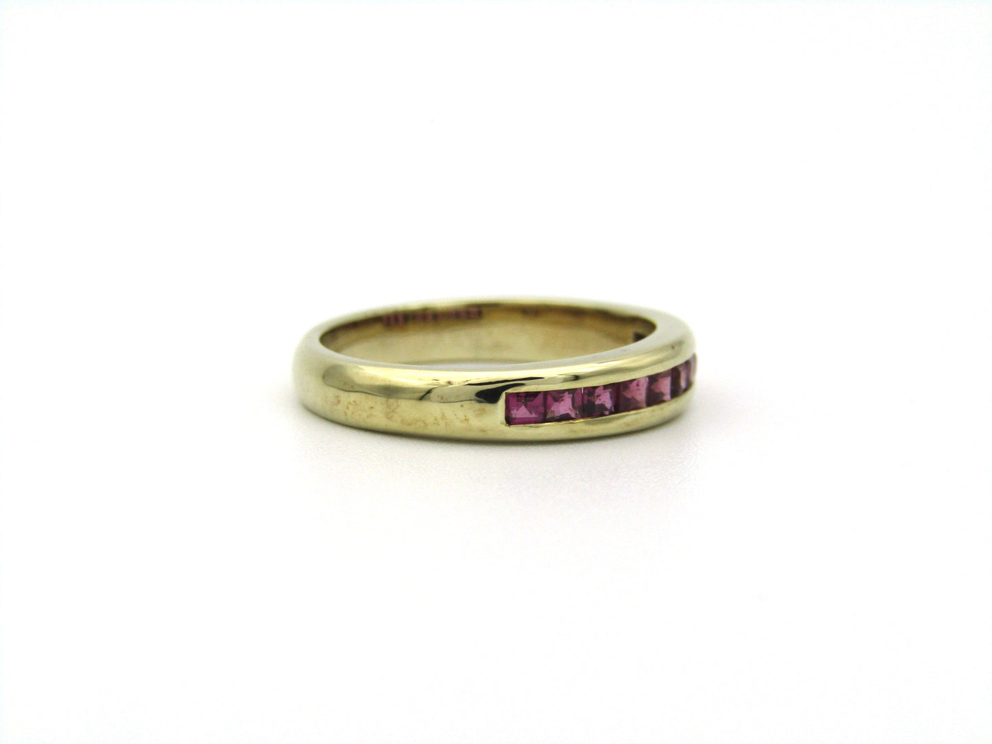 9K gold rhodolite garnet half eternity ring.