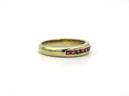 9K gold rhodolite garnet half eternity ring.