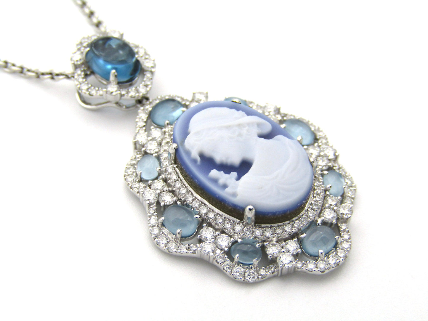 18K gold agate cameo, blue topaz and diamond pendant.
