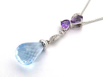 18K gold blue topaz, amethyst, and diamond pendant.