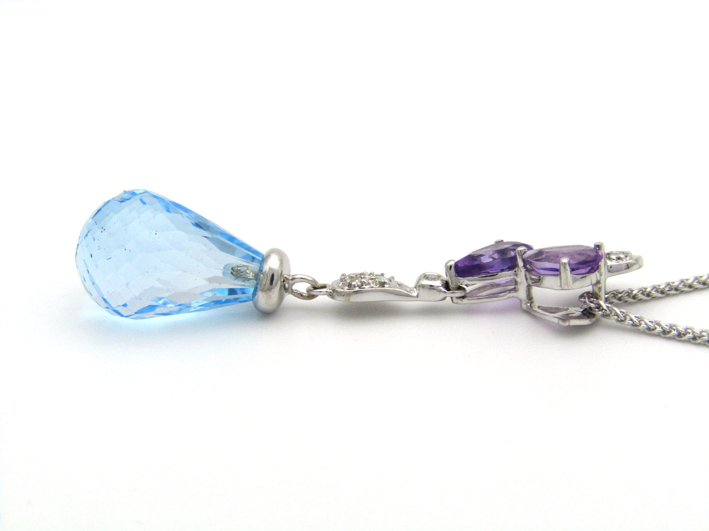 18K gold blue topaz, amethyst, and diamond pendant.