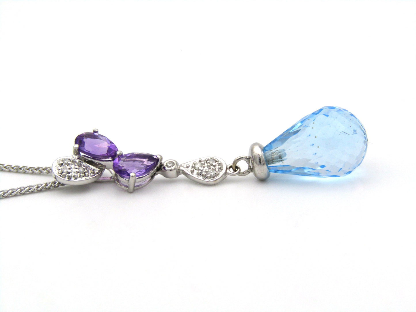 18K gold blue topaz, amethyst, and diamond pendant.
