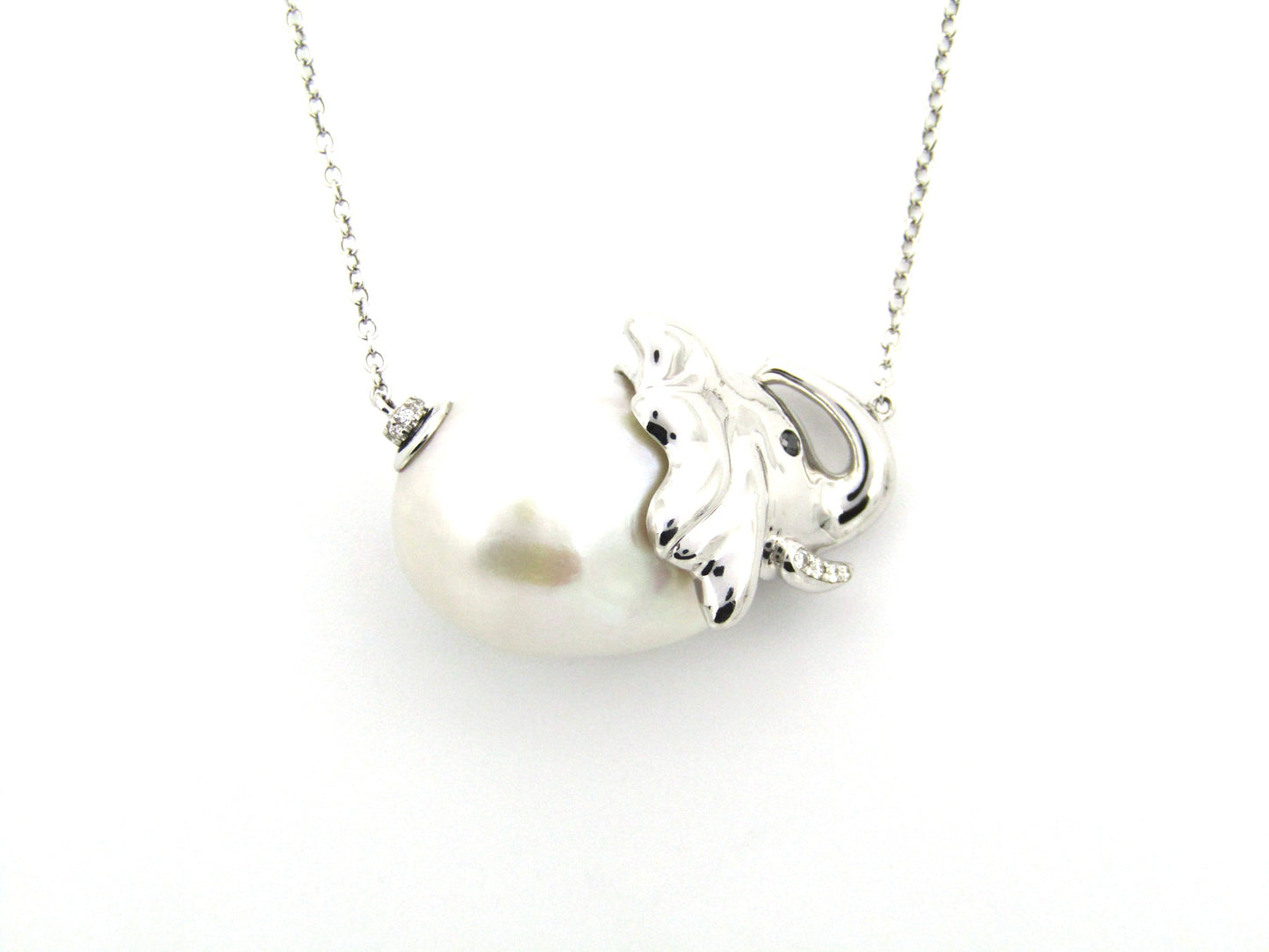 14K gold floating baroque pearl and diamond elephant necklace.