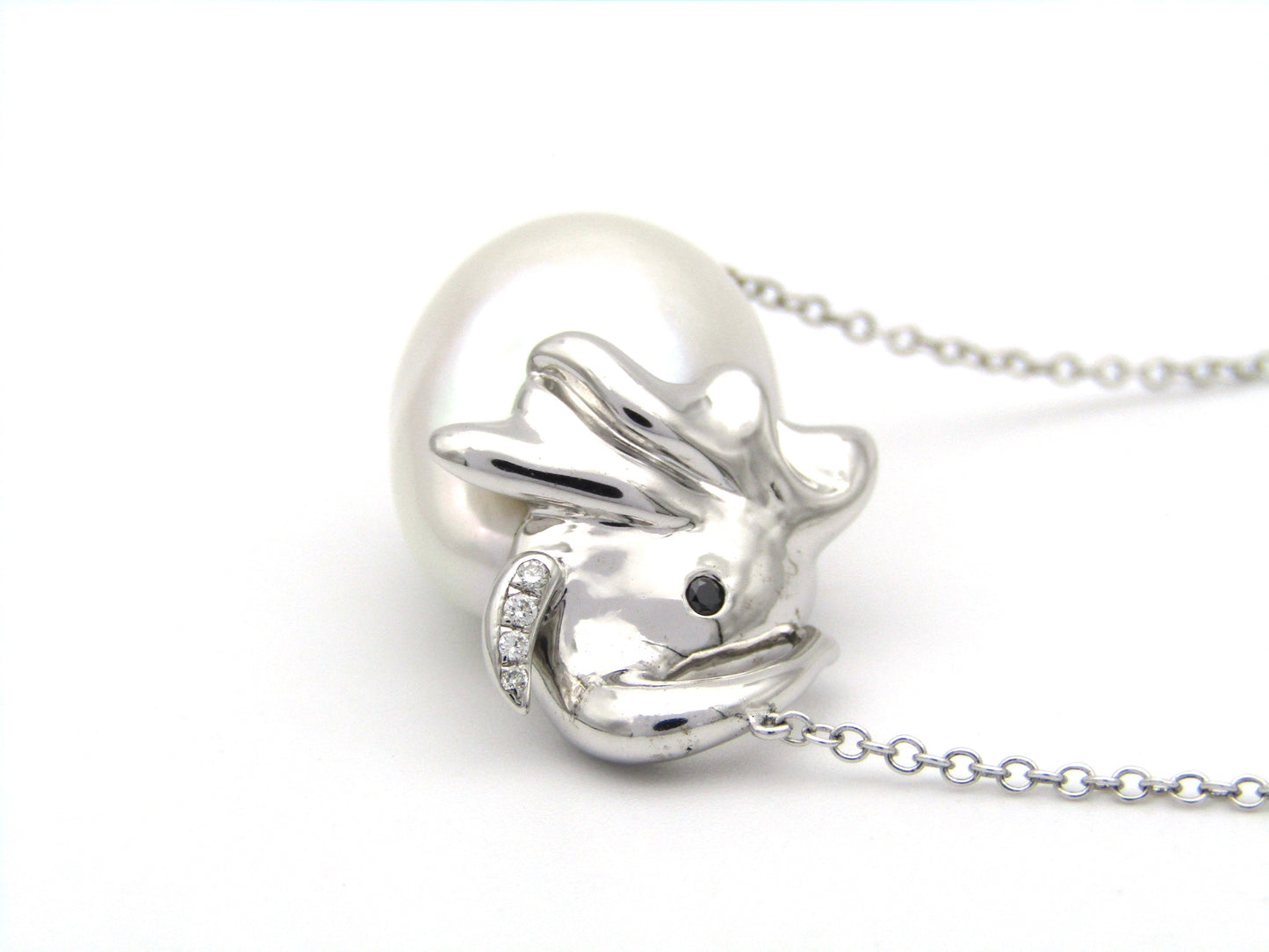 14K gold floating baroque pearl and diamond elephant necklace.