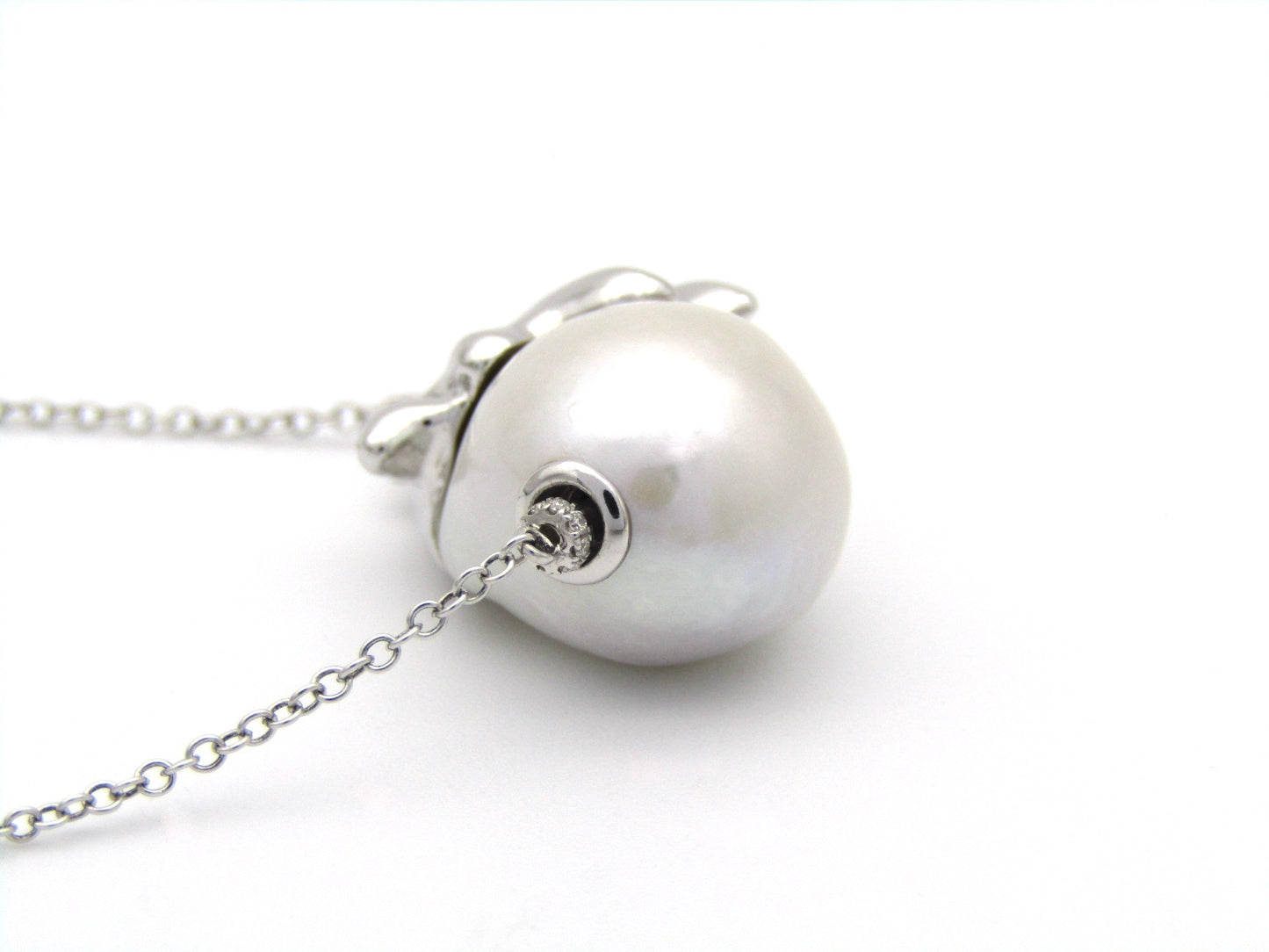 14K gold floating baroque pearl and diamond elephant necklace.