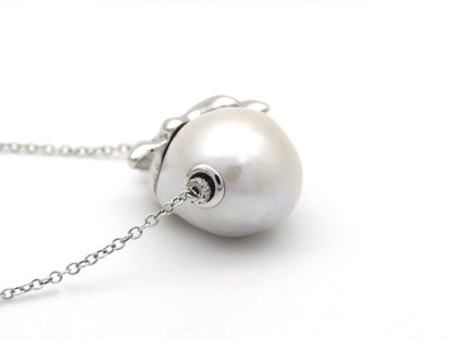 14K gold floating baroque pearl and diamond elephant necklace.