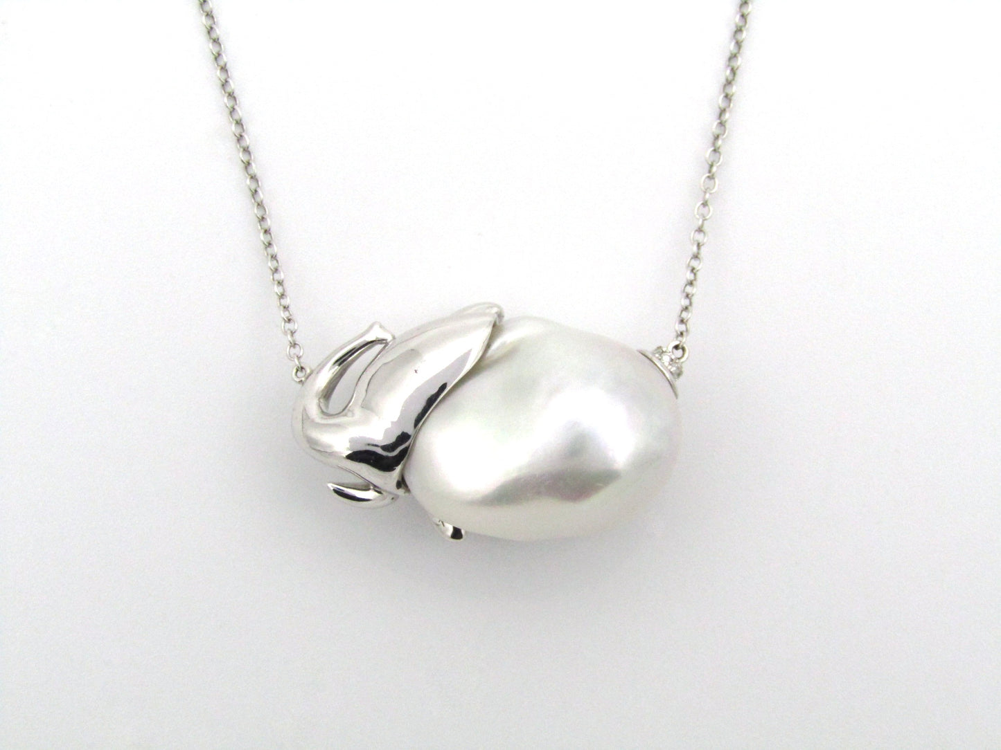 14K gold floating baroque pearl and diamond elephant necklace.
