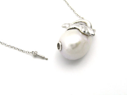 14K gold floating baroque pearl and diamond elephant necklace.
