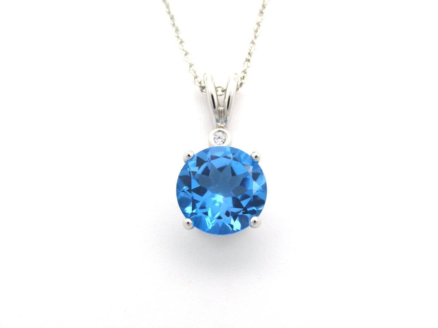 9K gold blue topaz and diamond pendant.