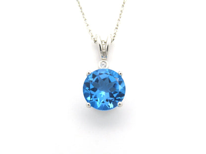 9K gold blue topaz and diamond pendant.
