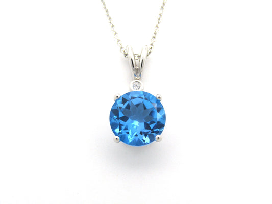 9K gold blue topaz and diamond pendant.