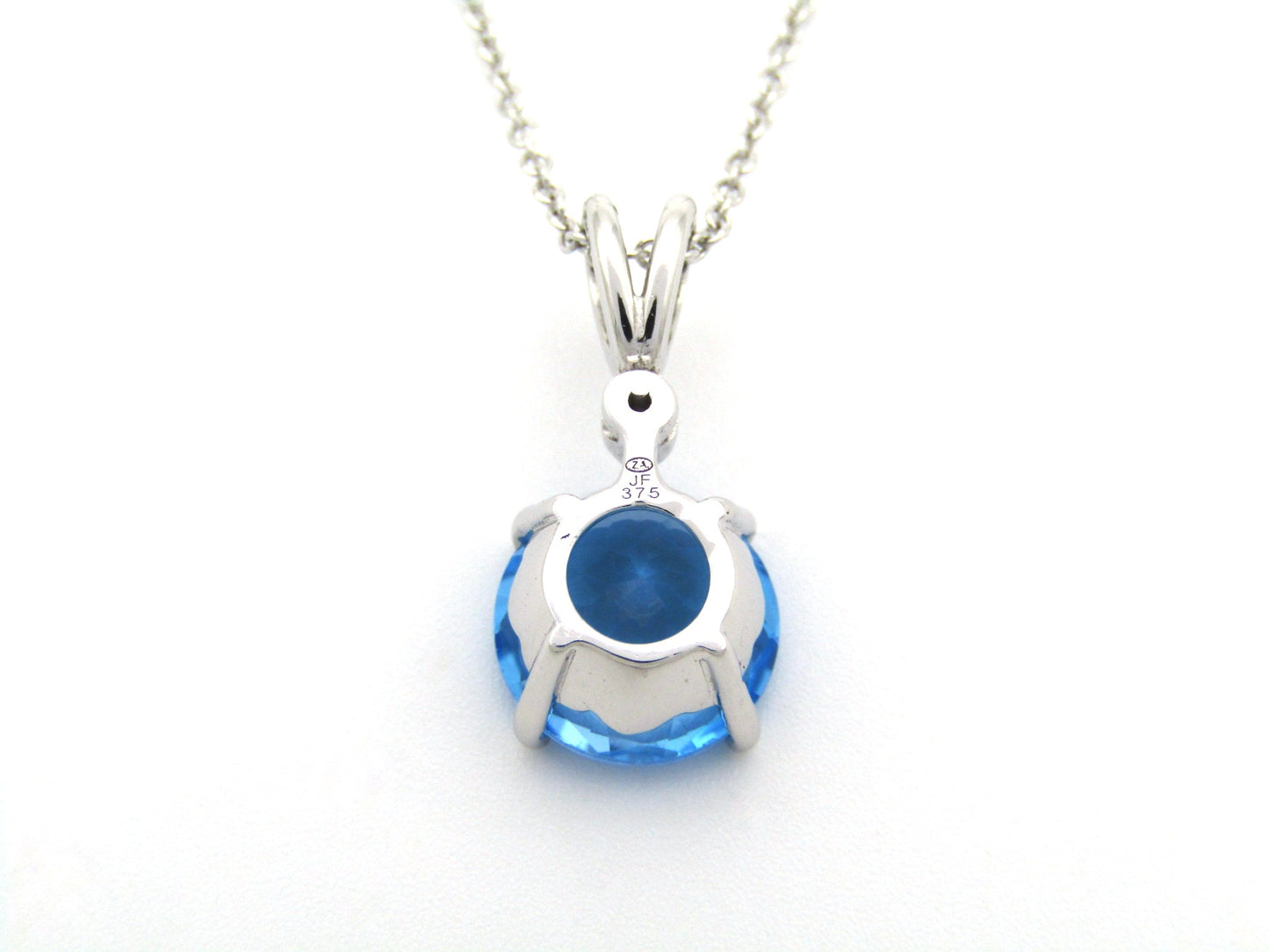 9K gold blue topaz and diamond pendant.