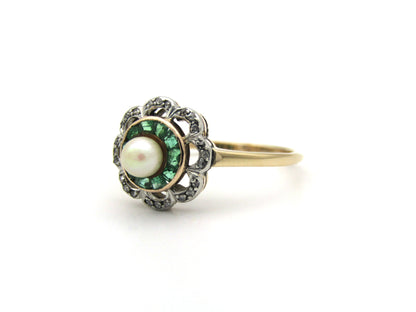 9K gold Edwardian pearl, emerald, and diamond flower ring.