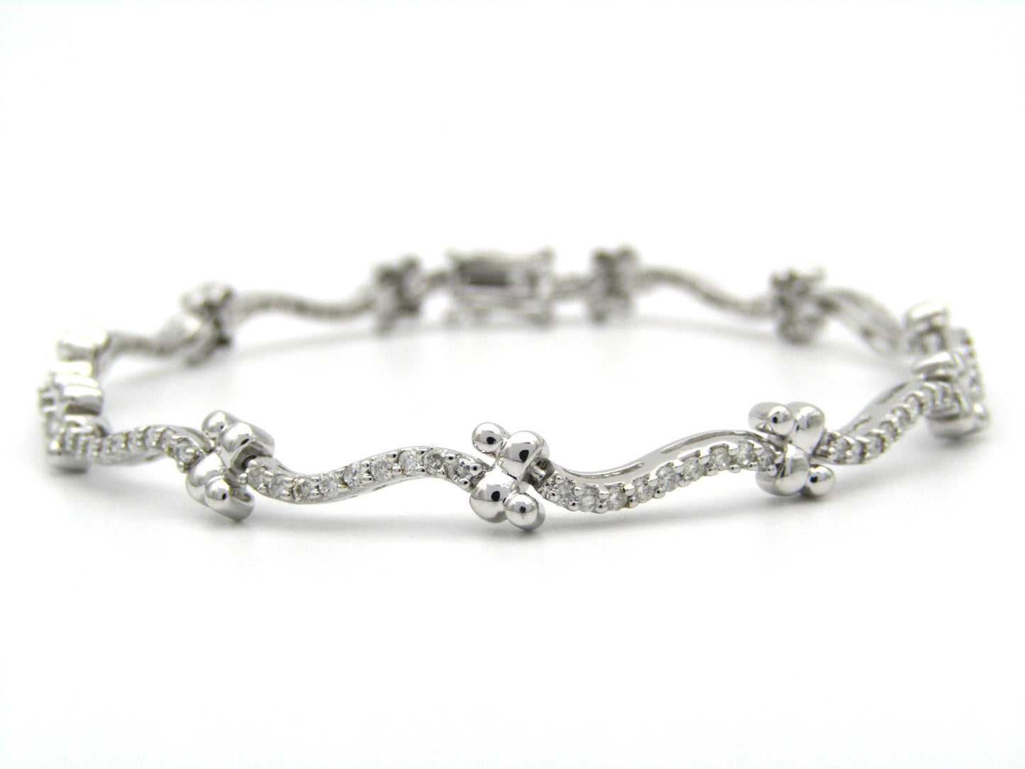 18K gold diamond wave link bracelet.