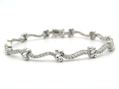 18K gold diamond wave link bracelet.